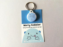 Load image into Gallery viewer, Worry gobbler mini round keyring. Blue cute blob character on a backing card with the words worry gobbler carry me with you wherever you go