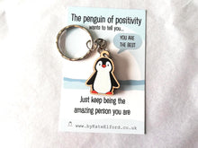 Load image into Gallery viewer, A mini cute wooden penguin keyring on a backing card with the wording the penguin of positivity wants to tell you, you are the best. Just keep being the amazing person you are