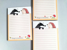 Load image into Gallery viewer, A6 badger and hedgehog lined notepad. At the bottom there are the words things to remember