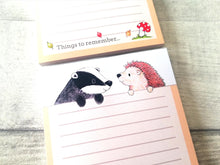 Load image into Gallery viewer, Top and bottom of two hedgehog and badger notepads, A6 lined note pads, the wording at the bottom reads things to remember,  with a picture of a toadstool and leaves blowing in the wind