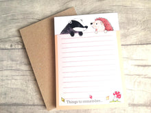 Load image into Gallery viewer, Hedgehog and badger notepad, A6 note pad, small lined planner, things to remember, autumn theme jotter pad with a red toadstool  and leaves at the bottom