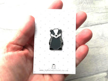 Load image into Gallery viewer, A badger enamel pin in a hand as a size guide