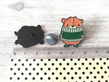 Load image into Gallery viewer, Brown bear in a green jumper enamel pin by a ruler as a size guide