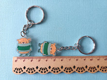 Load image into Gallery viewer, Brown bear recycled acrylic keyrings, next to a ruler as a size guide. They measure approximately 3cm tall