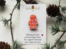 Load image into Gallery viewer, Christmas gingerbread pin gift. Responsibly resourced wood, eco friendly. Christmas gingerbread man. Gingerbread man is wearing a red and white scarf