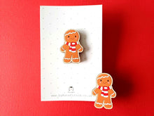 Load image into Gallery viewer, Christmas gingerbread pin, wooden pin brooch, Responsibly resourced wood, eco friendly. Christmas gingerbread man wearing a red and white scarf displayed on a white and grey polka dot backing card