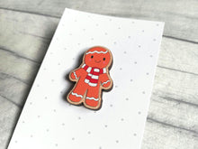 Load image into Gallery viewer, Christmas gingerbread pin, wearing a red and white scarf, wooden pin brooch, Responsibly resourced wood, eco friendly. Christmas gift