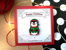 Load image into Gallery viewer, Happy Christmas elf penguin enamel pin. The backing card says Happy Christmas
