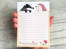 Load image into Gallery viewer, Notepad with a badger and hedgehog at the top, A6 lined note pad, the wording at the bottom reads things to remember,  with a picture of a toadstool and three leaves blowing in the wind, autumn themed jotter pad