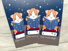 Load image into Gallery viewer, Three guinea pig bookmarks. The design is a ginger and white guinea pig sat on a book reading, with the wording one more page at the bottom of the bookmark