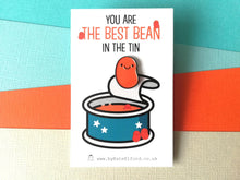 Load image into Gallery viewer, Best bean enamel pin, funny positive gift, mini enamel baked bean brooch, happy orange bean. The backing card has a blue tin picture and the wording you are the best bean in the tin