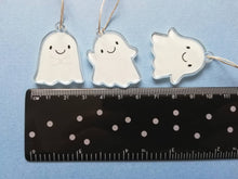 Load image into Gallery viewer, Ghost hanging decorations. Set of three small recycled acrylic ghosts. Cute happy little ghost ornaments. Next to a ruler to show the size. They measure around 3.5cm tall