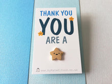 Load image into Gallery viewer, Tiny gold colour metal star enamel pin. The star has five points and a cute happy face. It is on a mini white rectangular backing card with the wording thank you you are a at the top and the star pin is attached at the bottom