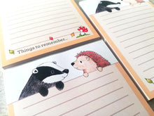 Load image into Gallery viewer, Hedgehog and badger notepad, A6 note pad, small lined planner, the wording at the bottom reads things to remember,  with a picture of a toadstool and three leaves blowing in the wind, autumn themed jotter pad