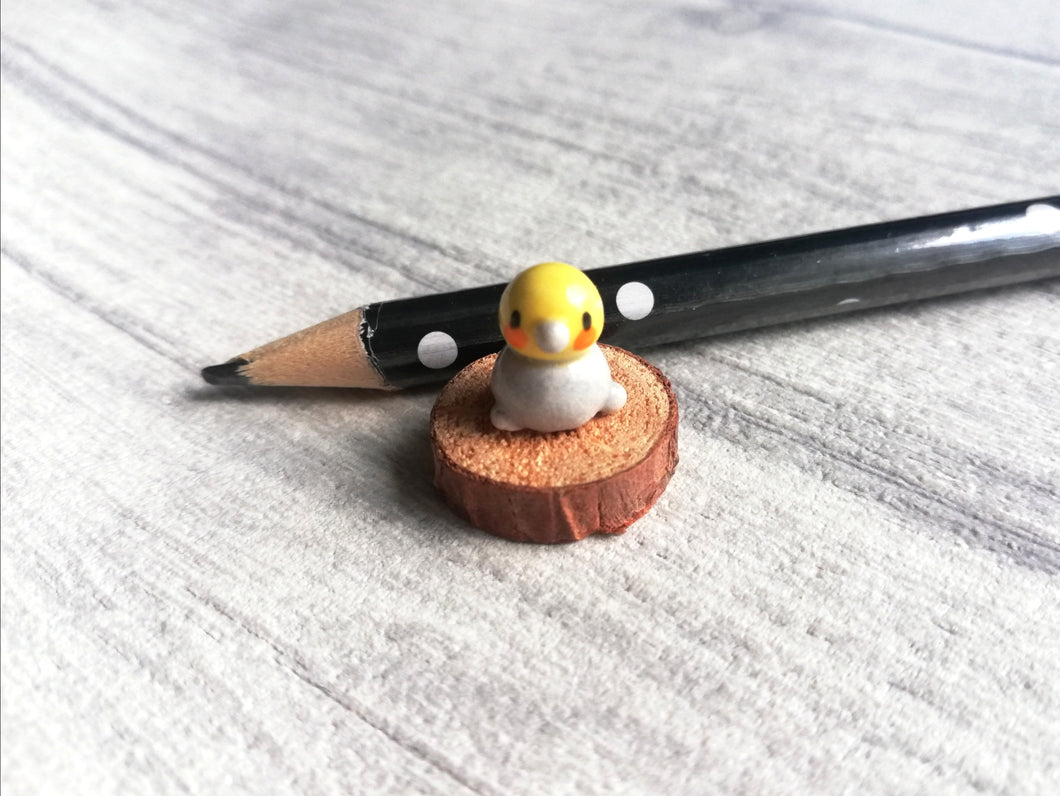 Miniature bird on wood base