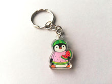 Load image into Gallery viewer, A little cute recycled acrylic penguin keyring. The mini penguin is wearing a watermelon hat and jumper and holding a slice of watermelon with a bite taken out of it.