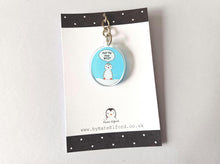 Load image into Gallery viewer, Mini oval recycled acrylic keyring. The design is a little penguin on a light blue background with a speech bubble saying you're the best. It is displayed on a small black and white backing card