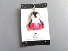 Load image into Gallery viewer, Penguin keyring. The penguin is holding the word mum in red and pink polka dot letters. It is made from recycled acrylic and sent on a small black and white card