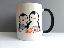 Load image into Gallery viewer, White mug with two penguins drinking tea. It has a black handle