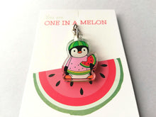 Load image into Gallery viewer, Mini penguin recycled acrylic keyring. A cute little penguin holding a slice of watermelon, dressed in a pale pink, yellow and green watermelon jumper and a watermelon hat. The wording on the backing card reads you are one in a melon. Instead of million