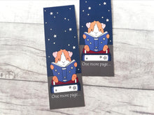 Load image into Gallery viewer, Guinea pig bookmark front and back. It is the same design on both sides. A ginger and white guinea pig sat on a book reading with a starry sky behind. The wording at the bottom says one more page