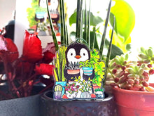 Load image into Gallery viewer, Penguin and house plants recycled acrylic hanger. Sat in front of real pot plants