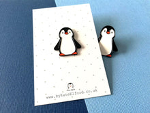 Load image into Gallery viewer, Black and white penguin enamel pin on a grey and white polka dot backing card with another penguin pin peeking out from behind the card