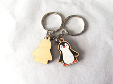 Load image into Gallery viewer, Front and back of a mini wooden penguin keyring. The back is plain wood