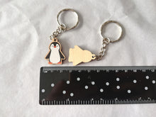 Load image into Gallery viewer, Mini penguin keyring by a ruler to show it measures around 2.5cm