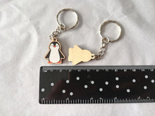 Load image into Gallery viewer, Penguin keyring next to a ruler to show how small it is. Approximately 2.5cm