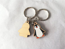 Load image into Gallery viewer, Back and front of a wooden penguin keyring. The back is plain wood