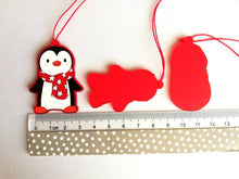 Load image into Gallery viewer, Christmas gift decorations. Red frosted acrylic penguin on a ruler as a size guide