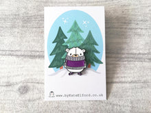 Load image into Gallery viewer, Cute little polar bear enamel pin. The bear is wearing a purple jumper and matching stripe socks