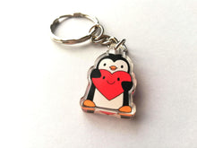 Load image into Gallery viewer, Mini acrylic penguin holding a happy face red heart keyring.