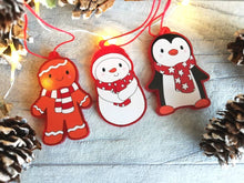 Load image into Gallery viewer, Christmas gift decorations. Red frosted acrylic penguin, snowman or gingerbread man. Cute Christmas tree hangers. They are all wearing matching red and white scarves