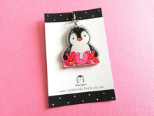 Load image into Gallery viewer, A cute happy penguin holding the word mum in red and pink polka dot letters. Made from recycled acrylic and displayed on a small black and white display card