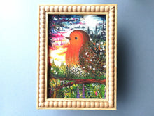 Load image into Gallery viewer, A busy painting of a robin surrounded by a night sky, a sunrise, trees, plants and flowers. The colours are subtly rainbow themed. It is sold unframed, but is shown here in a frame