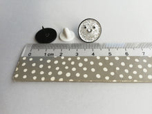 Load image into Gallery viewer, Seconds - A spot of sparkle pin, mini enamel pin, small round silver glitter pin with a happy face next to a ruler as a size guide. It measures approximately 16mm