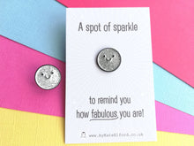 Load image into Gallery viewer, Seconds - A spot of sparkle pin, mini round silver glitter enamel pin with a smiley face. The mini backing card is light grey with a white burst of lines coming out from the centre. It reads A spot of sparkle to remind you how fabulous you are. There is a little pin displayed next to the card as well