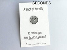 Load image into Gallery viewer, Seconds - A spot of sparkle pin, mini round silver glitter enamel pin with a smiley face. The mini backing card is light grey with a white burst of lines coming out from the centre. It reads A spot of sparkle to remind you how fabulous you are