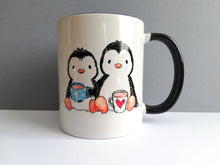 Load image into Gallery viewer, Two penguins sat drinking tea design on a white ceramic mug, with a  lack handle