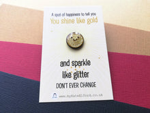 Load image into Gallery viewer, A small cute round gold glittery enamel pin with a happy smiley face. It is on a rectangular backing card which has the wording a spot of happiness to tell you you shine like gold and sparkle like glitter. Don't ever change. Designed by Kate Elford