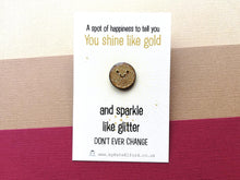 Load image into Gallery viewer, A mini round gold glittery enamel pin with a very sparkly happy face. It is on a rectangular backing card which has the wording a spot of happiness to tell you you shine like gold and sparkle like glitter. Don't ever change. Designed by Kate Elford
