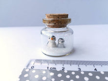 Load image into Gallery viewer, Miniature penguin Christmas decoration. Little pottery penguins and chick in a glass bottle. Christmas penguin mini ornament, mothers day