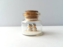 Load image into Gallery viewer, Miniature penguin Christmas decoration. Little pottery penguins in a glass bottle. Christmas, valentine penguin mini ornament