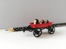Load image into Gallery viewer, Penguins in a cart. Little pottery penguin in a mini red truck. Cute penguins
