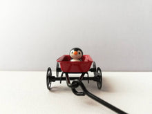 Load image into Gallery viewer, Penguins in a cart. Little pottery penguin in a mini red truck. Cute penguins