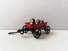 Load image into Gallery viewer, Penguins in a cart. Little pottery penguin in a mini red truck. Cute penguins