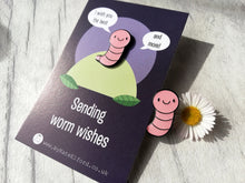 Load image into Gallery viewer, Pink worm enamel pin. It is on a backing card with the wording sending worm wishes, I wish you the best and more
