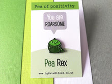 Load image into Gallery viewer, A little round green dinosaur enamel pin. The message on the card says pea of positivity, you are roarsome, pea rex